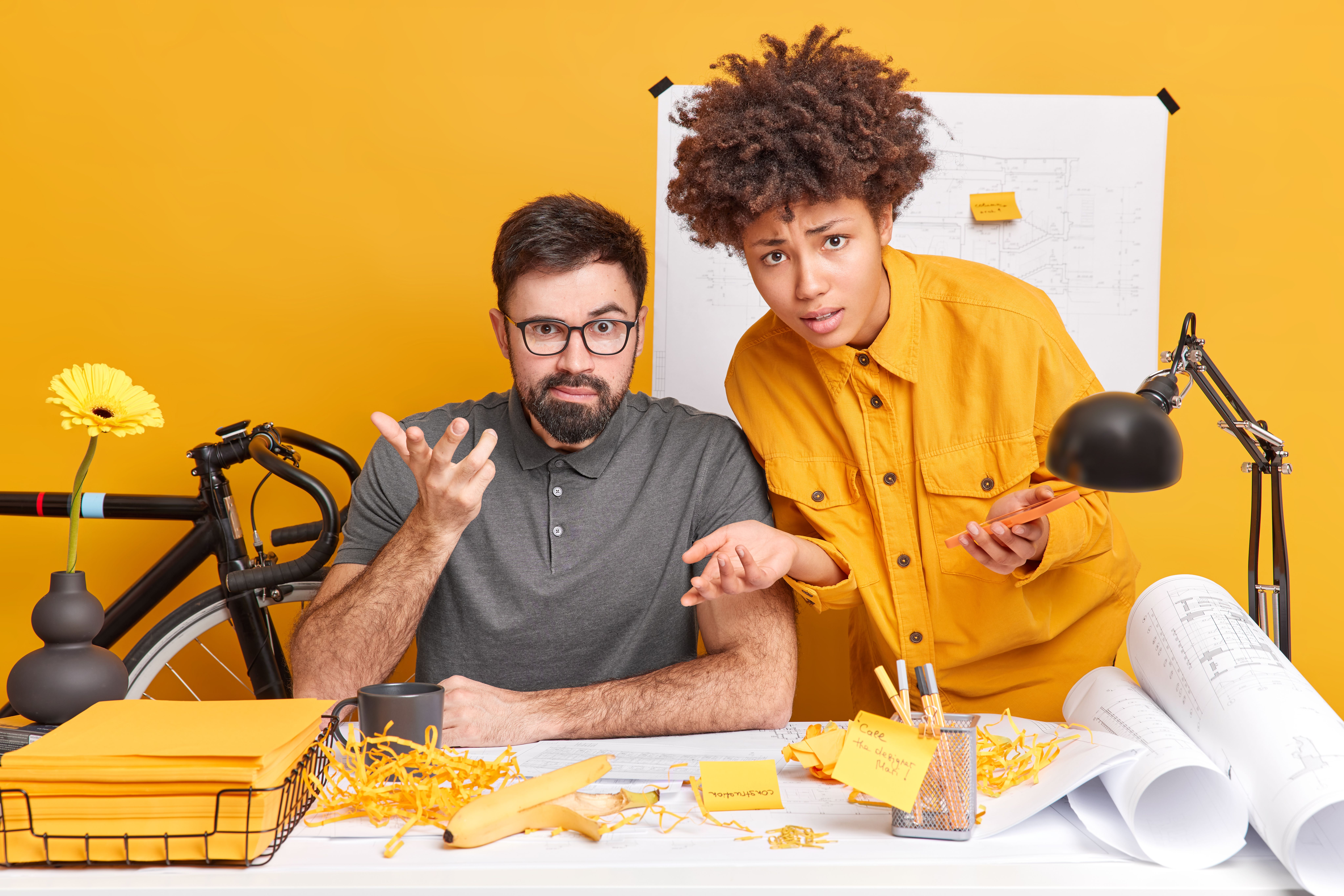 puzzled-interracial-woman-man-look-puzzled-while-working-office-draw-sketch-future-building-construction-look-indignant-pose-desktop-concentrated-job.jpg